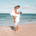 engagement session outer banks obx maryksphotography boy lifting girl by ocean