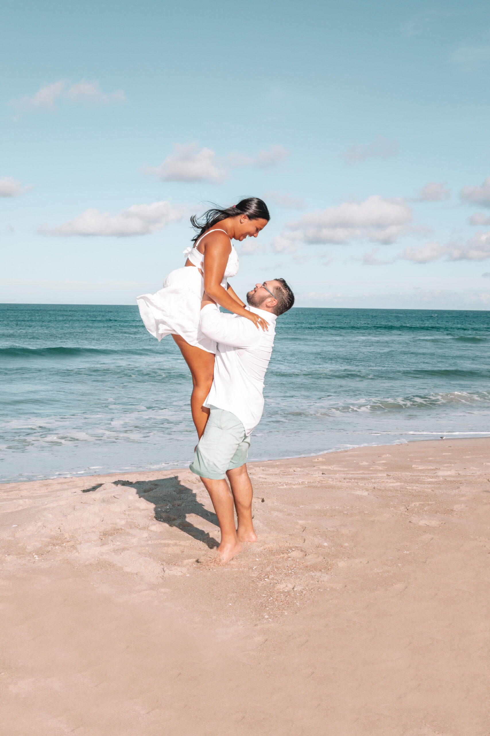 engagement session outer banks obx maryksphotography boy lifting girl by ocean