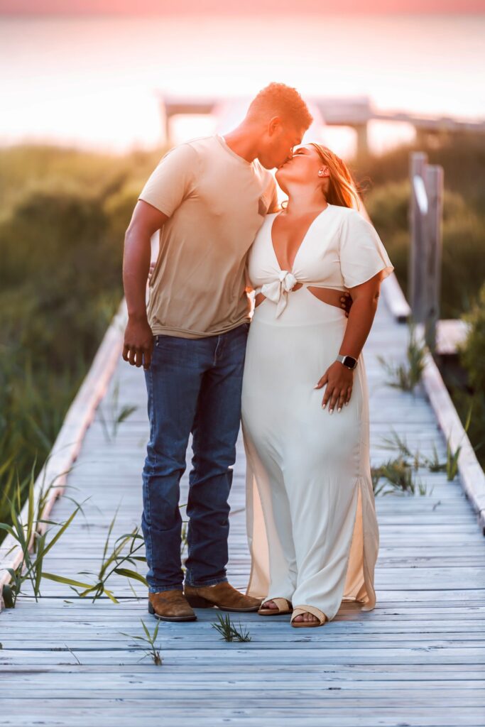 obx family beach photography and weddings mary ks photography obxsunset sunglow engagement photo of couple kissing on beach outer banks obx